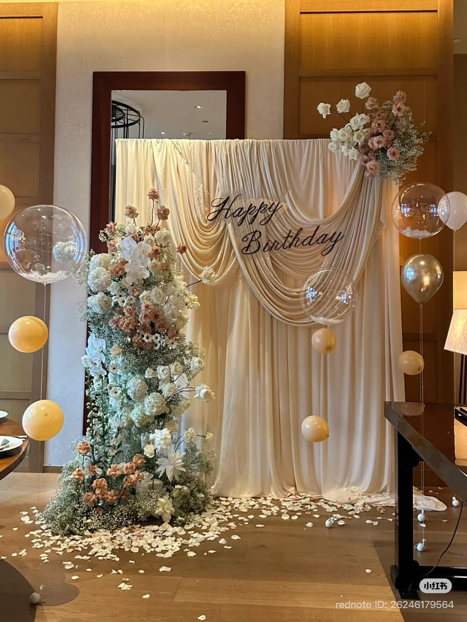 Cream draped Happy Birthday backdrop with blush florals and balloons