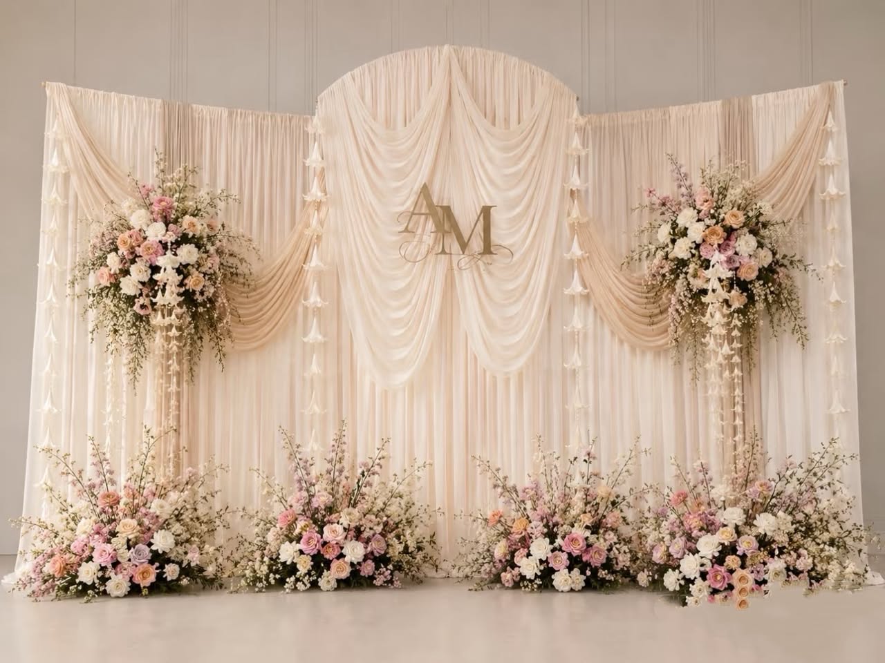 Champagne draped backdrop with pastel floral clusters